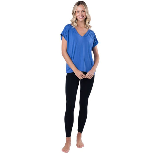 female model wearing ocean blue alicia v-neck top abd black suri leggings front view on white background