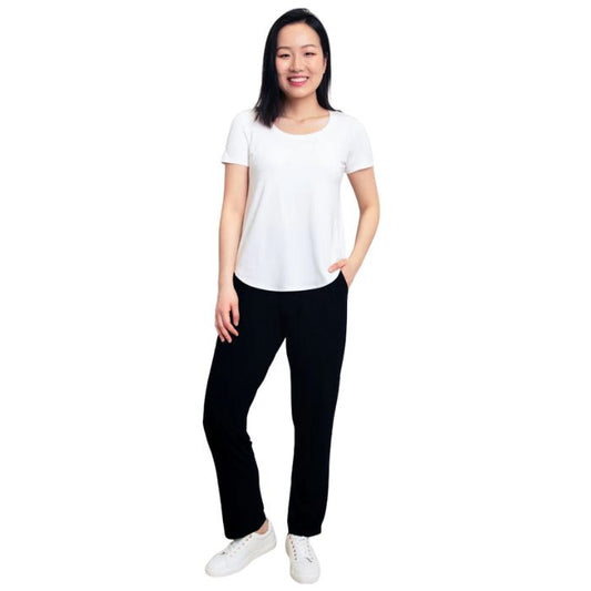 female model wearing black clair pants and white tessa tee front view on white background