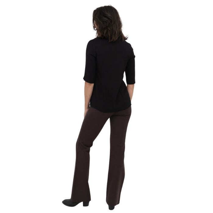 female model wearing coffee brown daya pants and black lorrine blouse back view on white background