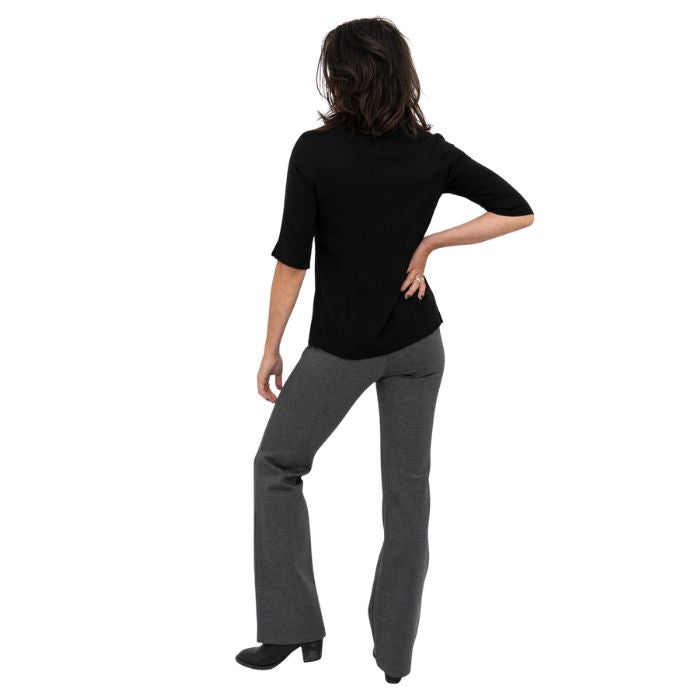 female model wearing granite grey daya pants and black lorrine blouse back view on white background