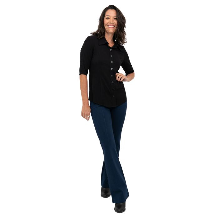 female model wearing indigo blue daya pants and black lorrine blouse front view on white background