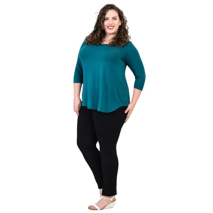 female model wearing jazz teal green three quarter sleeve top and nadia black pants front view on white background