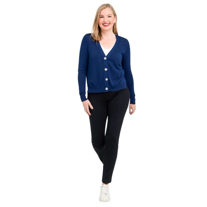 female model wearing jessica indigo blue button up cardigan sweater, reanna white tank top and nadia black pants front view on white background