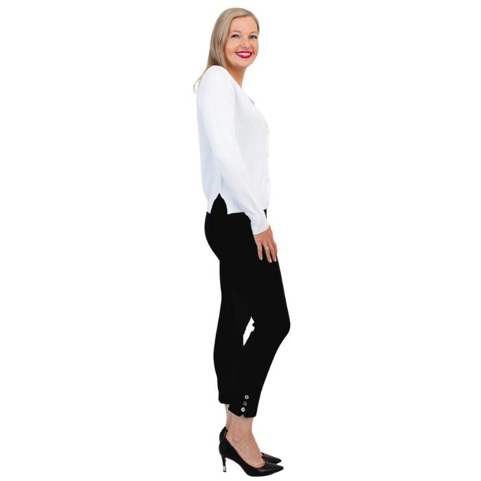 female model wearing jessica white button up cardigan sweater, reanna black tank top and nadine black cropped pants side view on white background