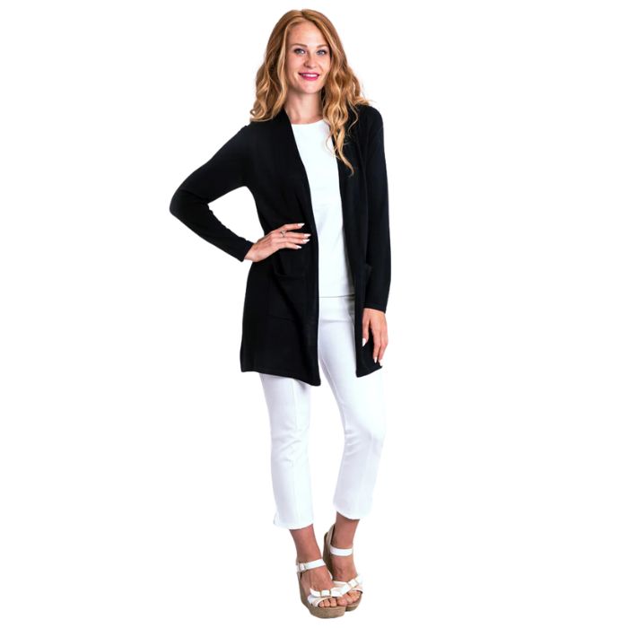 female model wearing justine black draped cardigan sweater and nadine white croppped pants front view on white background