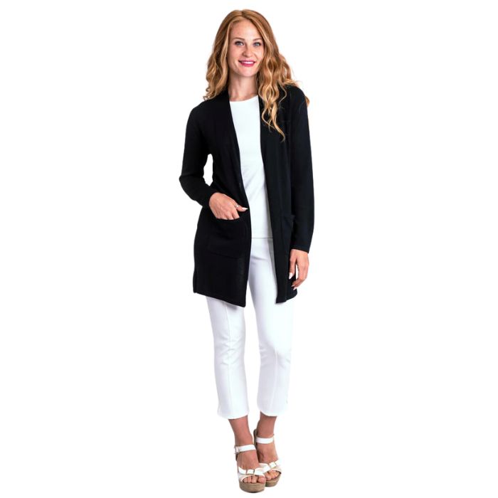 female model wearing justine black draped cardigan sweater and nadine white croppped pants front view on white background