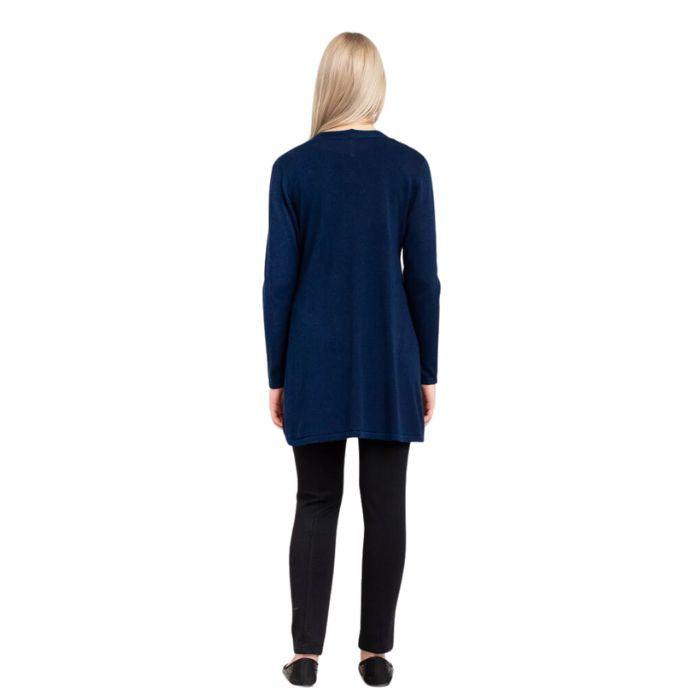 female model wearing justine indigo blue draped cardigan sweater, jazz black tank top and nadia black pants back view on white background