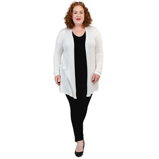 female model wearing justine white draped cardigan sweater over reanna black tank top and nadia black pants front view on white background