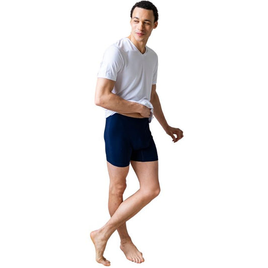 male model wearing ink blue boxer briefs and white huron v-neck tee front view on white background