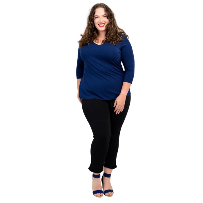 female model wearing mia indigo blue three quarter sleeve top and nadine black cropped pants front view on white background