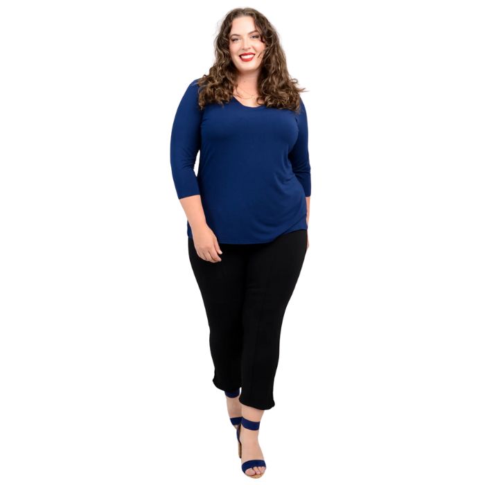 female model wearing mia indigo blue three quarter sleeve top and nadine black cropped pants front view on white background