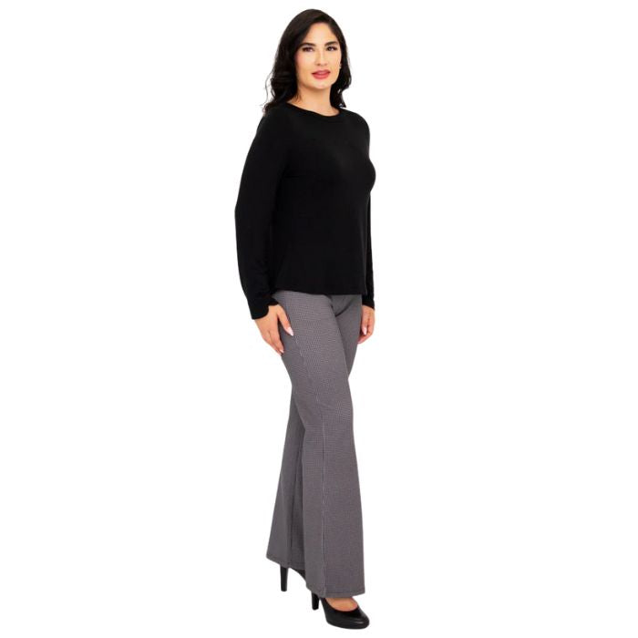 female model wearing mona black long sleeve top and daya pants side view on white background