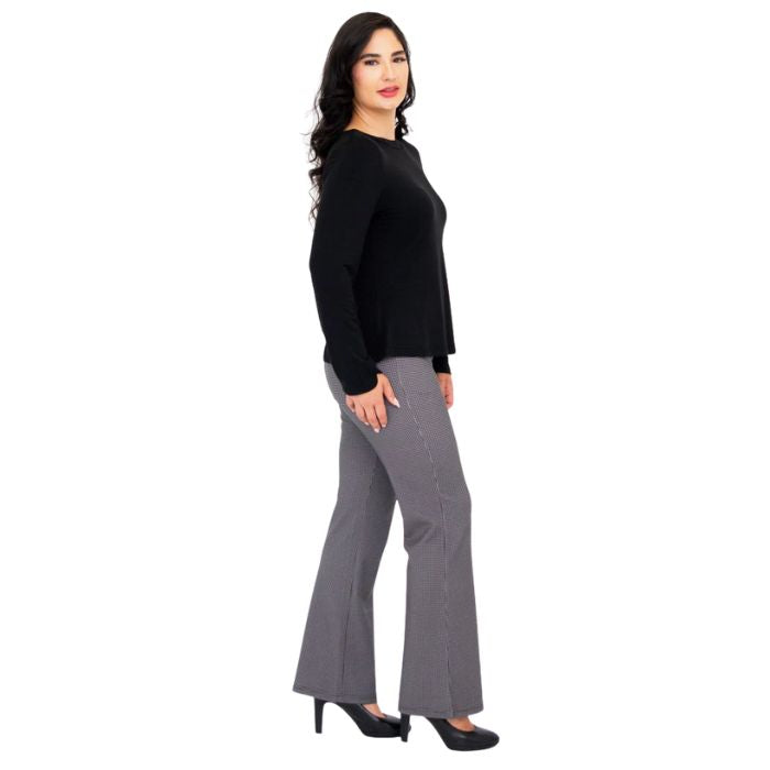 female model wearing mona black long sleeve top and daya pants side view on white background