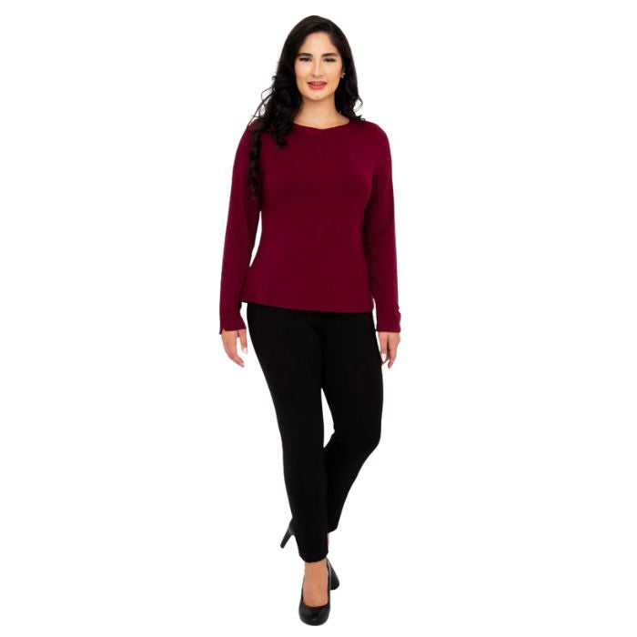female model wearing mona burgundy red long sleeve top and nadia black pants front view on white background