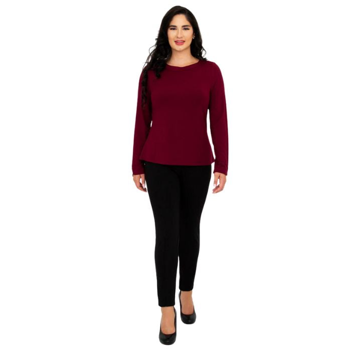 female model wearing mona burgundy red long sleeve top and nadia black pants front view on white background