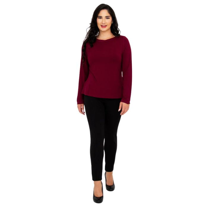 female model wearing mona burgundy red long sleeve top and nadia black pants front view on white background