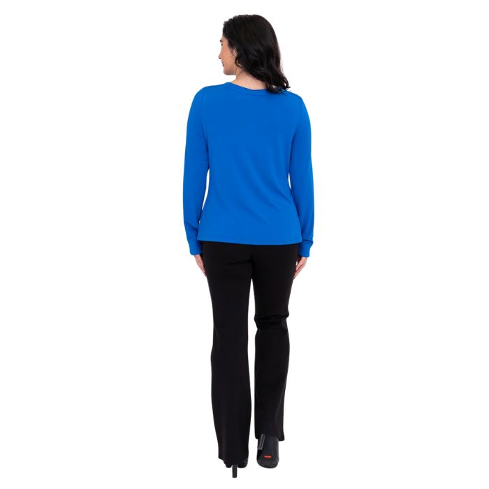 female model wearing mona cobalt blue long sleeve top and daya black pants front view on white background