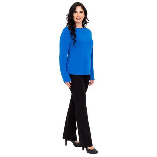 female model wearing mona cobalt blue long sleeve top and daya black pants front view on white background