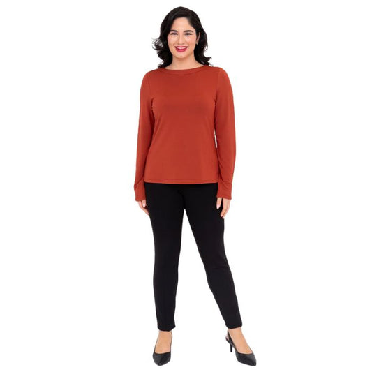 female model wearing mona cuprum orange long sleeve top and nadia black pants front view on white background