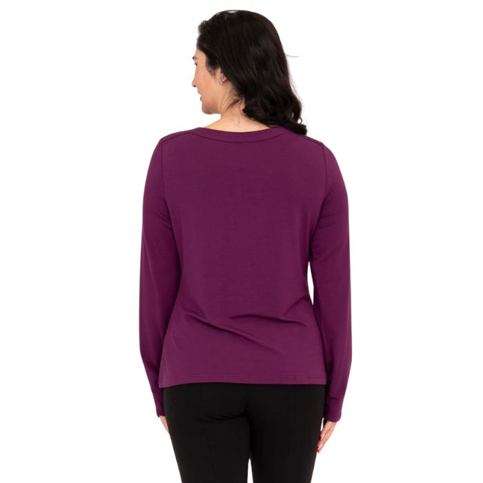 top of female model wearing mona magenta purple long sleeve top back view on white background