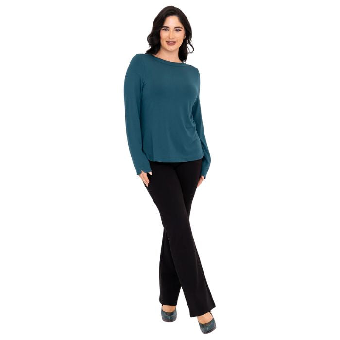 female model wearing mona teal green long sleeve top and daya black pants front view on white background