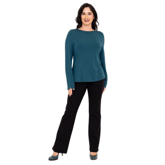 female model wearing mona teal green long sleeve top and daya black pants front view on white background