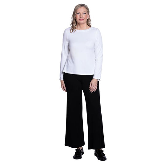 female model wearing mona white long sleeve top and daya black pants front view on white background