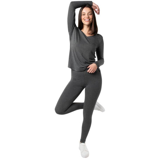 female model wearing charcoal grey suri capri length leggings and charcoal grey ellie v-neck top front view on white background