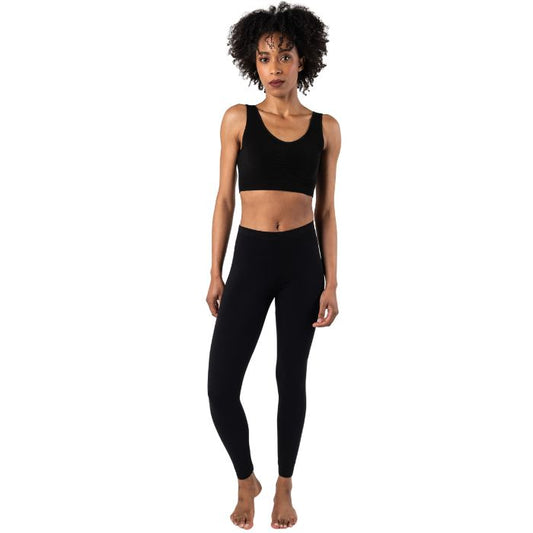 female model wearing black suri full length leggings and black terrera essential bralette front view on white background