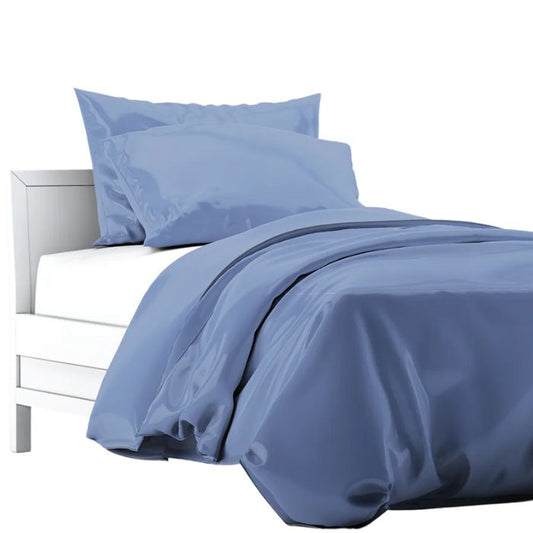 a bed made with mineral blue terrera duvet cover and two pillowcases on white background