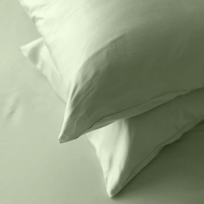 desert sage green terrera two bamboo pillowcases on pillows stacked on bed