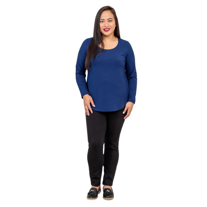 female model wearing tessa long sleeve top indigo blue and nadia black pants front view on white background