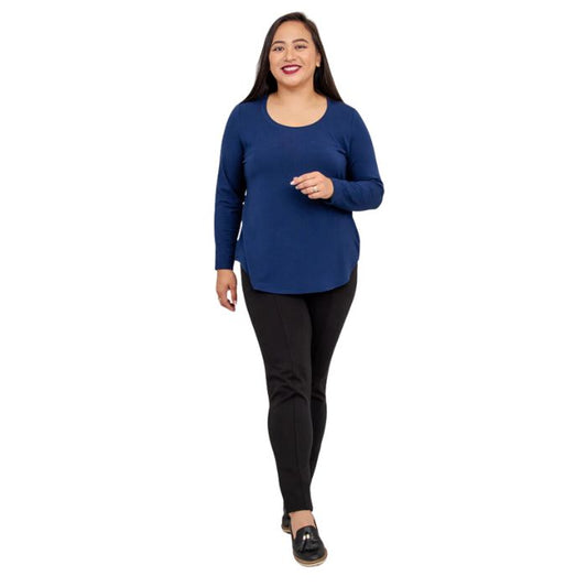 female model wearing tessa long sleeve top indigo blue and nadia black pants front view on white background