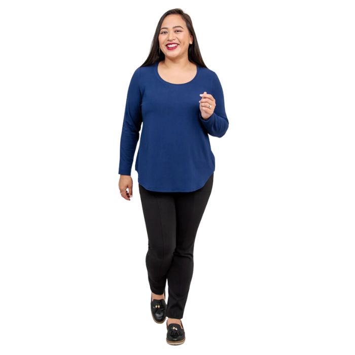 female model wearing tessa long sleeve top indigo blue and nadia black pants front view on white background