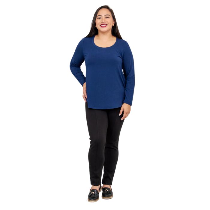 female model wearing tessa long sleeve top indigo blue and nadia black pants front view on white background