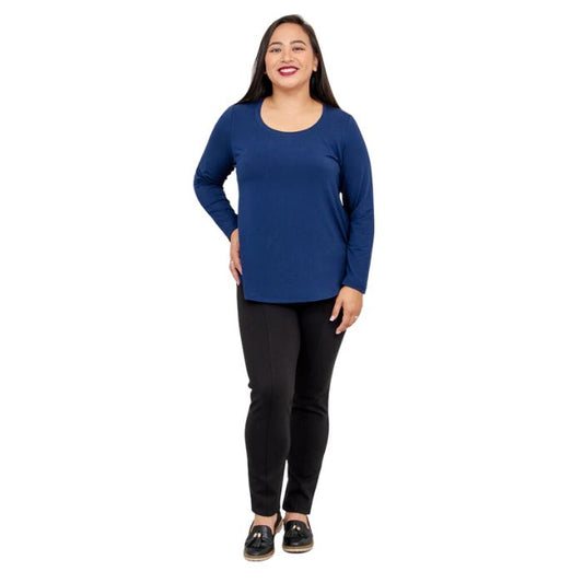 female model wearing tessa long sleeve top indigo blue and nadia black pants front view on white background