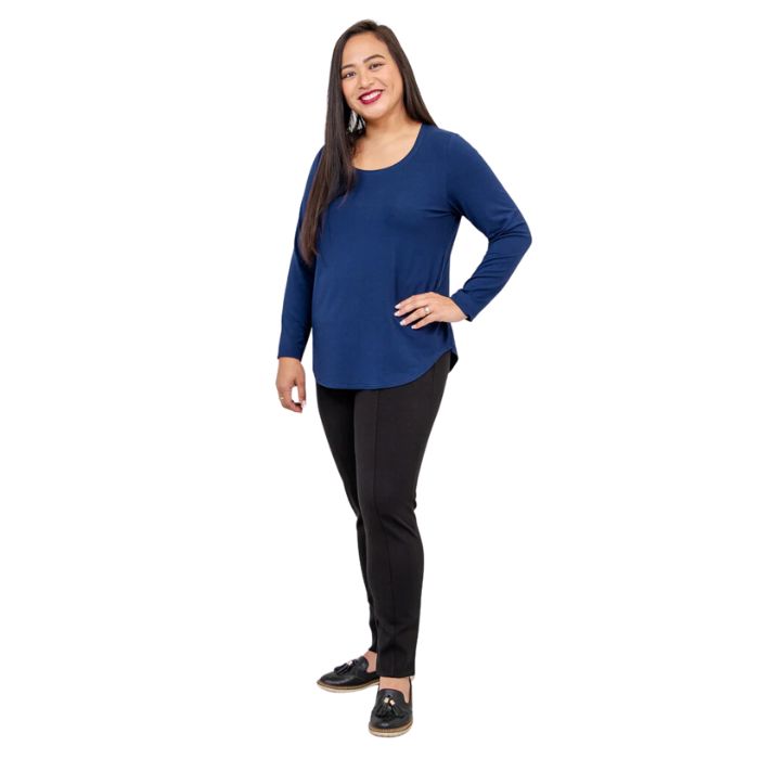 female model wearing tessa long sleeve top indigo blue and nadia black pants side view on white background
