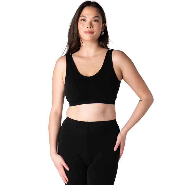 female model wearing black essential bralette front view on white background