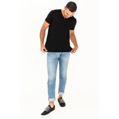 male model wearing black huron v-neck t-shirt and blue jeans front view on white background