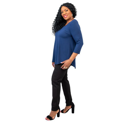 female model wearing jazz indigo blue three quarter sleeve top and nadia black pants side view on white background
