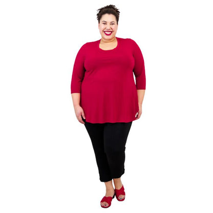 female model wearing lipstick red jazz top and black nadine cropped pants front view on white background