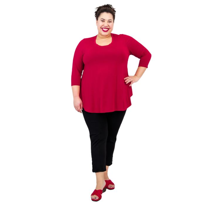 female model wearing lipstick red jazz top and black nadine cropped pants front view on white background