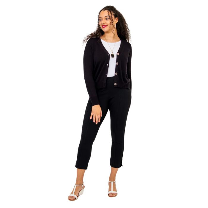 female model wearing black jessica button up cardigan sweater white reanna tank top and black nadine cropped pants front view on white background