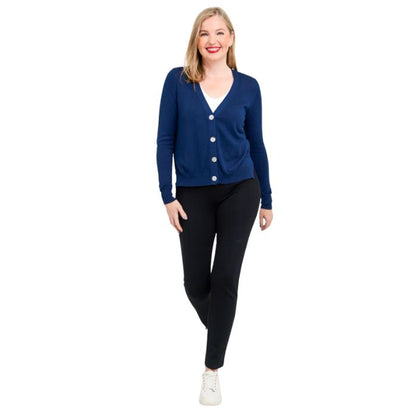 female model wearing jessica indigo blue button up cardigan sweater, reanna white tank top and nadia black pants front view on white background