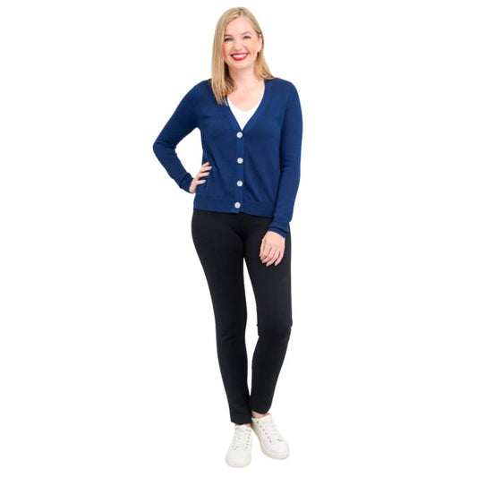 female model wearing indigo blue jessica button up cardigan sweater, white reanna tank top and black nadia pants front view on white background