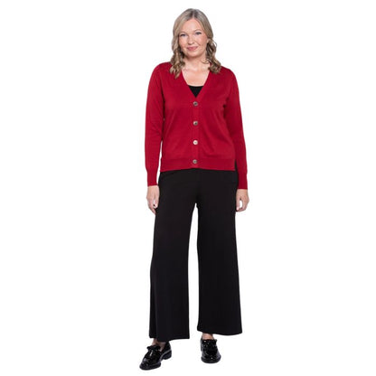 female model wearing lipstick red jessica button up cardigan sweater, black reanna tank top and black landon capri pants front view on white background