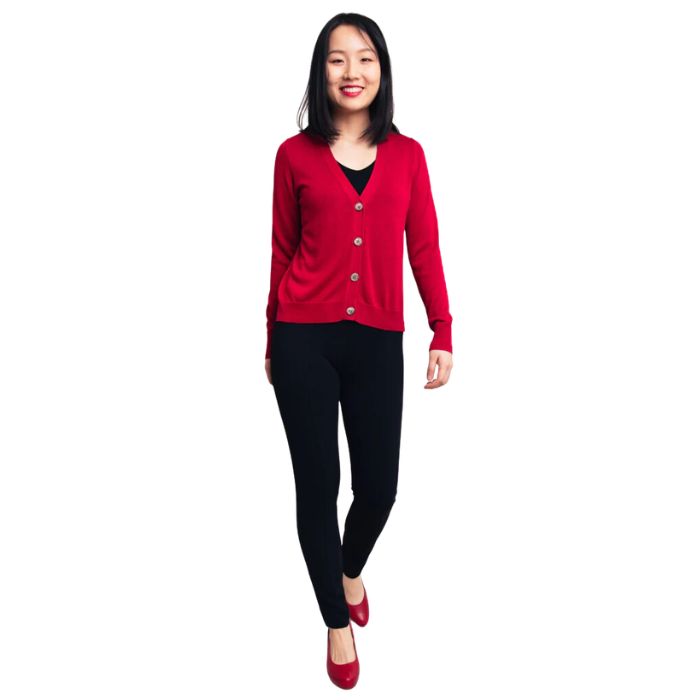 female model wearing lipstick red jessica button up cardigan sweater, black reanna tank top and black nadia pants front view on white background