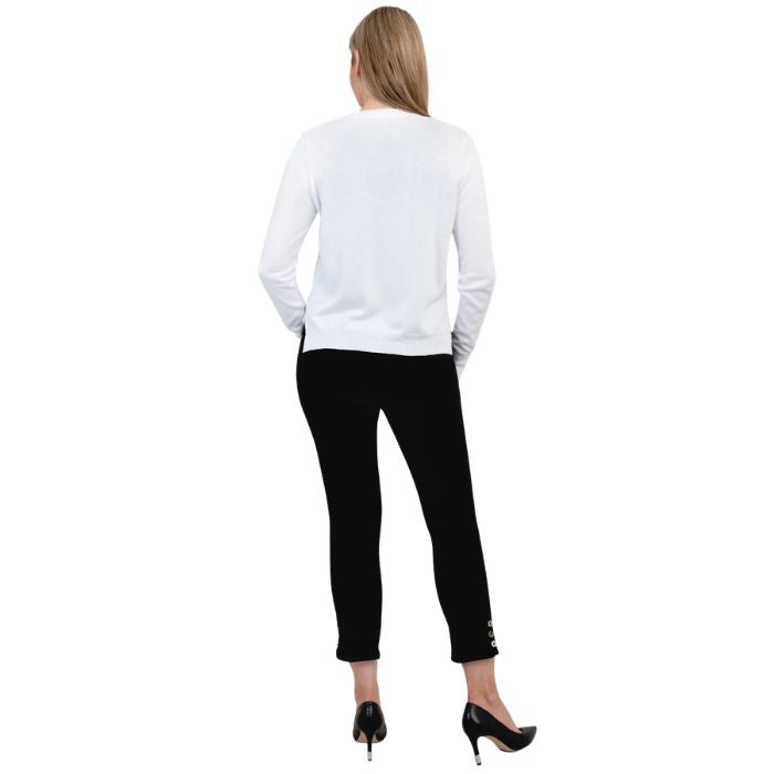female model wearing white jessica button up cardigan sweater, black reanna tank top and black nadine cropped pants back view on white background