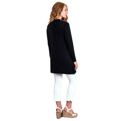 female model wearing justine black draped cardigan sweater and nadine white croppped pants back view on white background