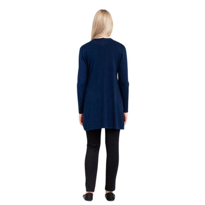 female model wearing justine indigo blue draped cardigan sweater, jazz black tank top and nadia black pants back view on white background